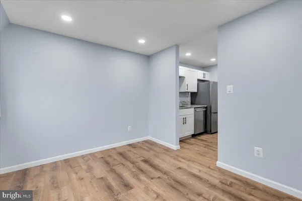 a view of a kitchen with a sink and wooden floor