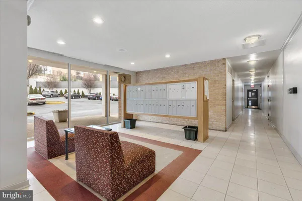 a living room with stainless steel appliances granite countertop furniture and a large window