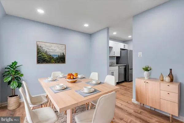 a view of a dining room with furniture and a potted plant