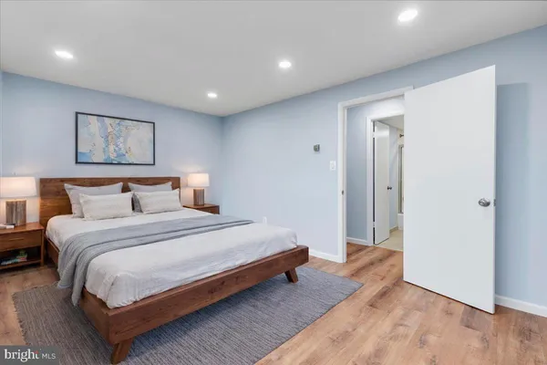 a bedroom with a bed and a painting