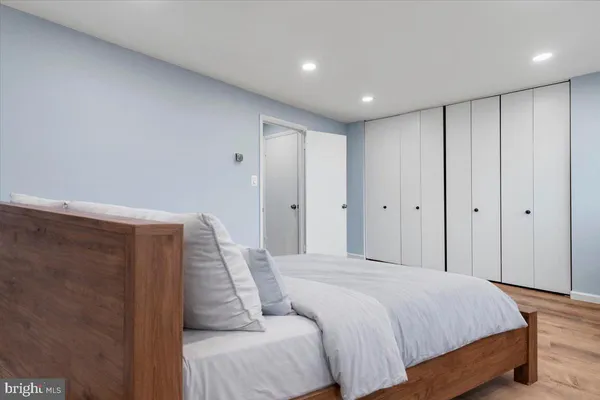 a spacious bedroom with a bed and a shower