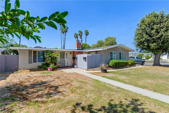 a front view of a house with a yard and a garage
