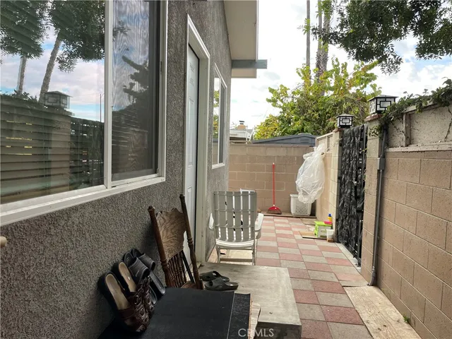 a view of a chairs and table in backyard of the house