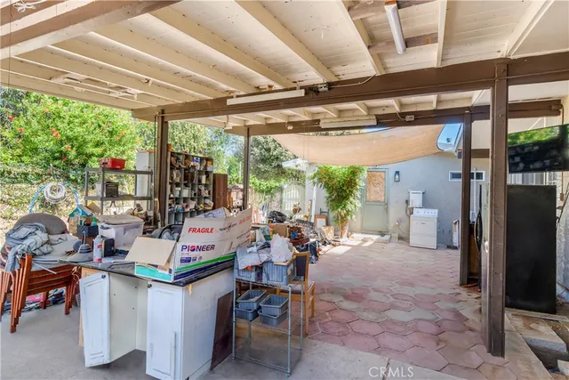a view of a patio with a table and chairs