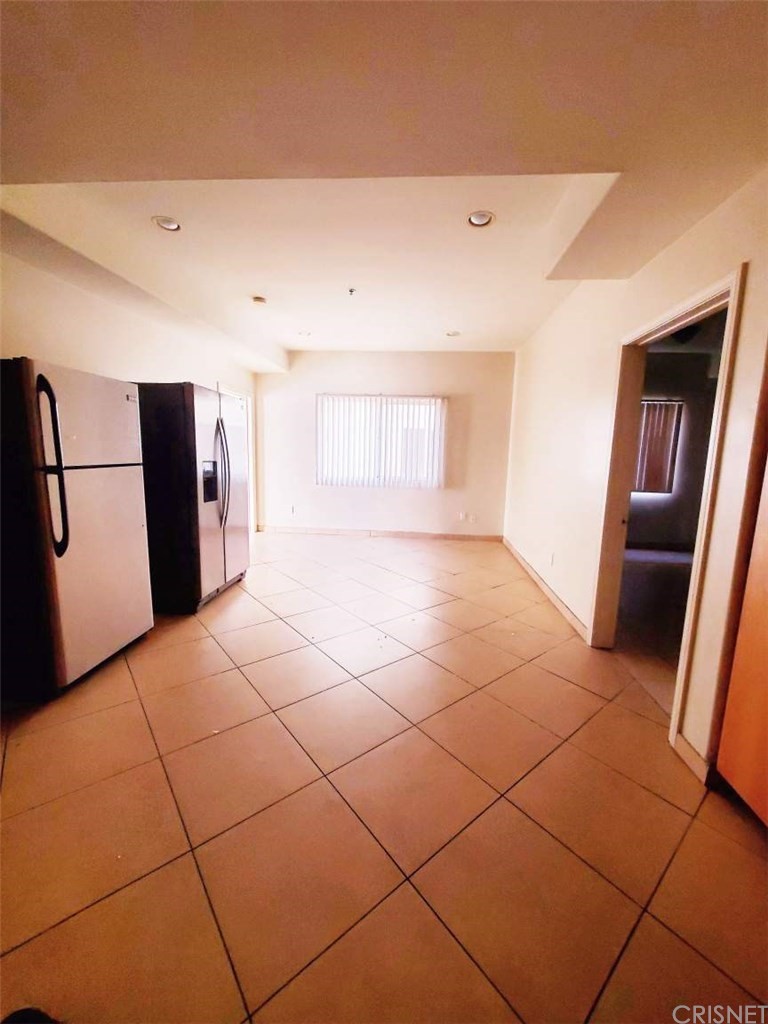 a view of a livingroom with a refrigerator