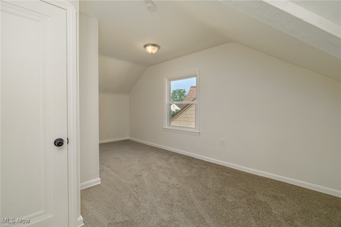 12727 Grannis Road Cleveland, OH 44125 - Photo 26 of 43 Bonus room featuring lofted ceiling and light colored carpet