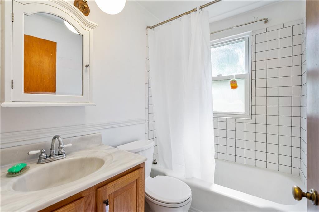 2509 Kane Road Aliquippa, PA 15001 - Photo 12 of 27 a bathroom with a granite countertop bathtub sink vanity mirror and toilet