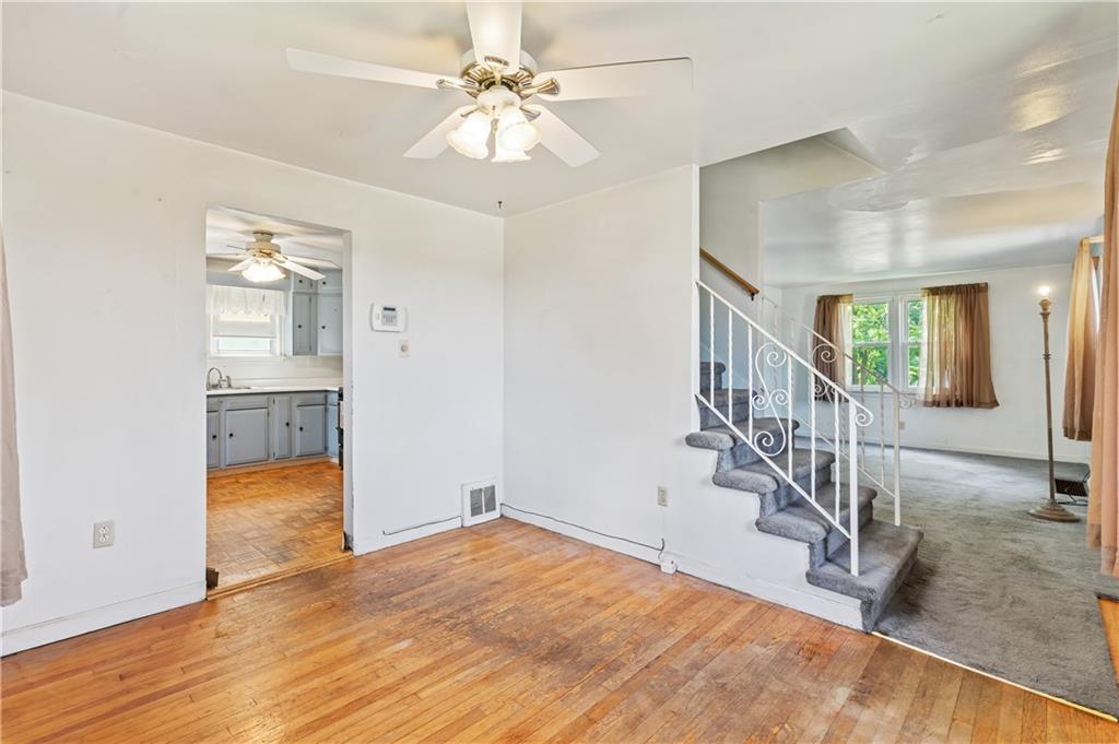 2509 Kane Road Aliquippa, PA 15001 - Photo 10 of 27 an empty room with wooden floor and staircase