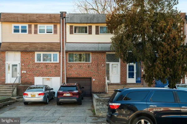 a front view of a house with parking space