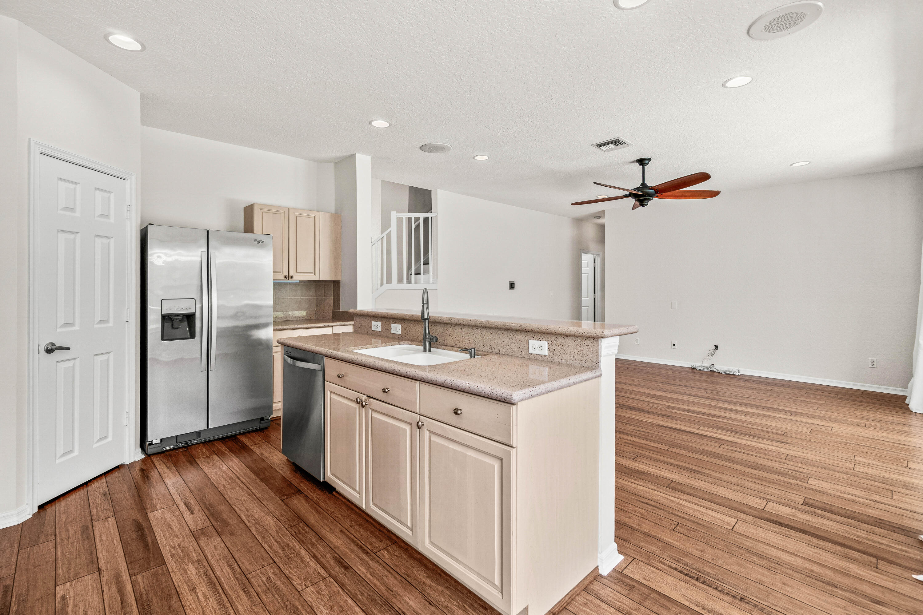 207 Pennock Trace Drive Jupiter, FL 33458 - Photo 11 of 48 a kitchen with a sink refrigerator and wooden floor