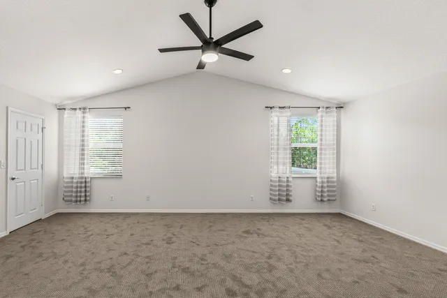 an empty room with a empty space and a ceiling fan