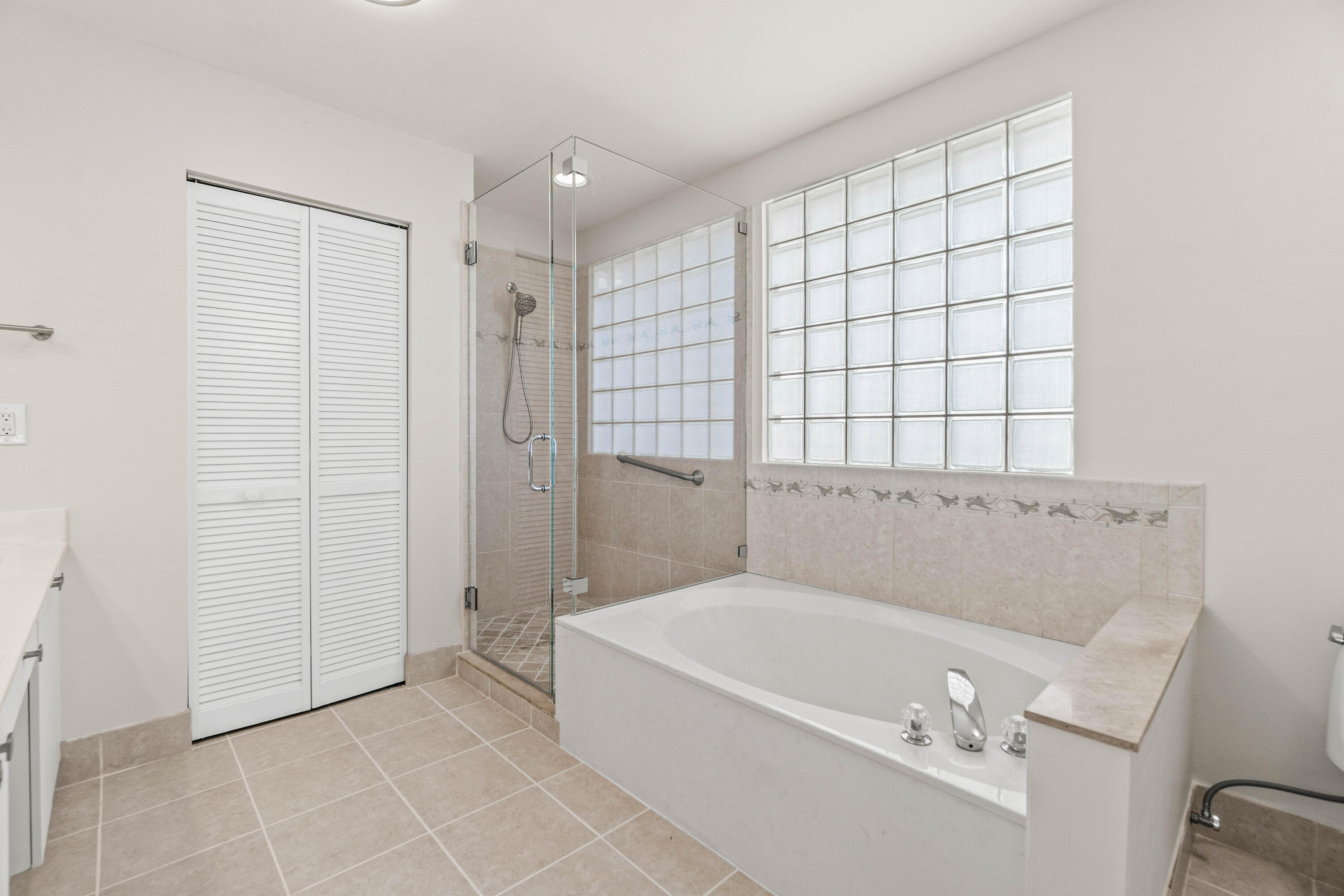 207 Pennock Trace Drive Jupiter, FL 33458 - Photo 20 of 48 a bathroom with a bathtub and shower