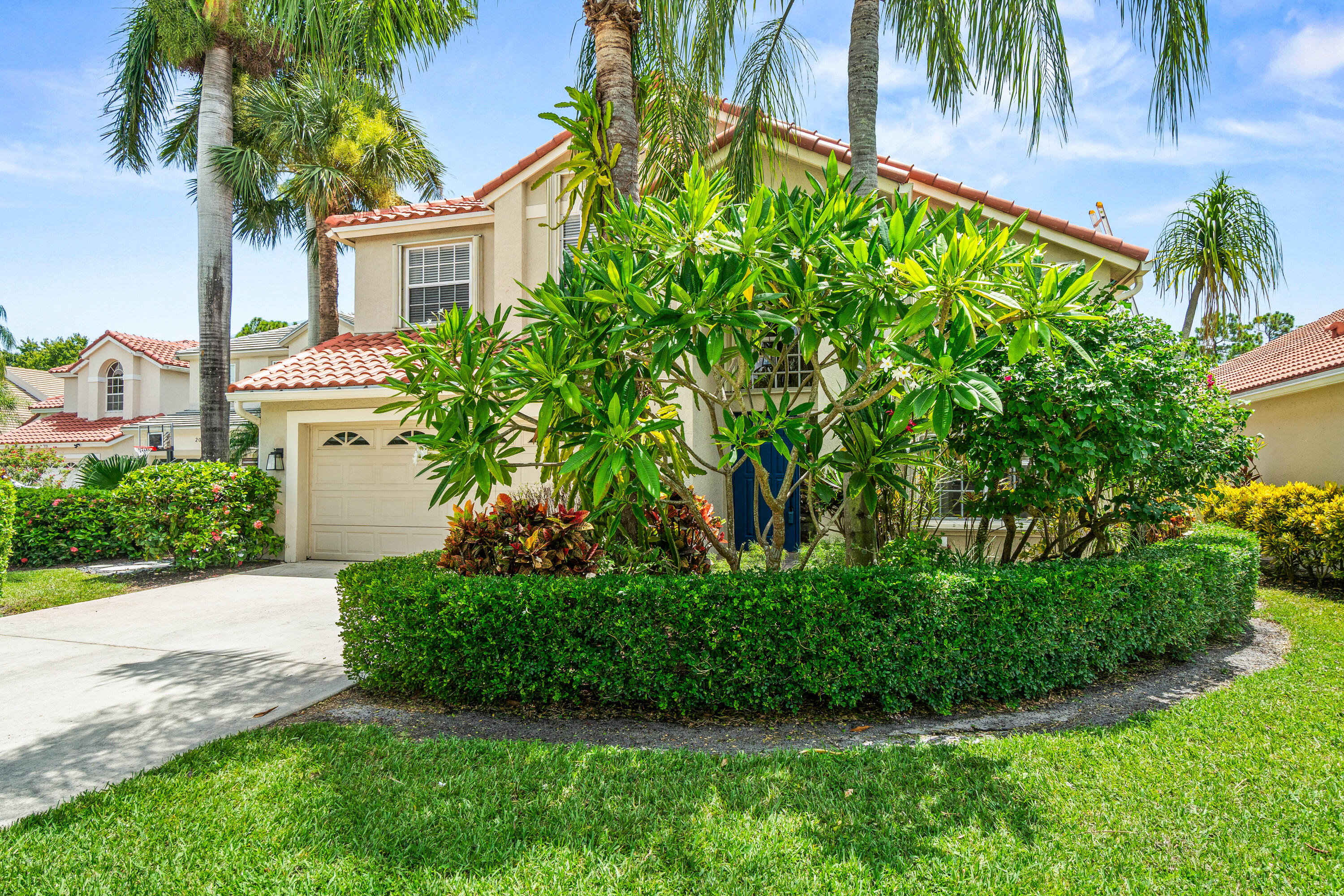 207 Pennock Trace Drive Jupiter, FL 33458 - Photo 2 of 48 a view of a garden with a plants and palm trees