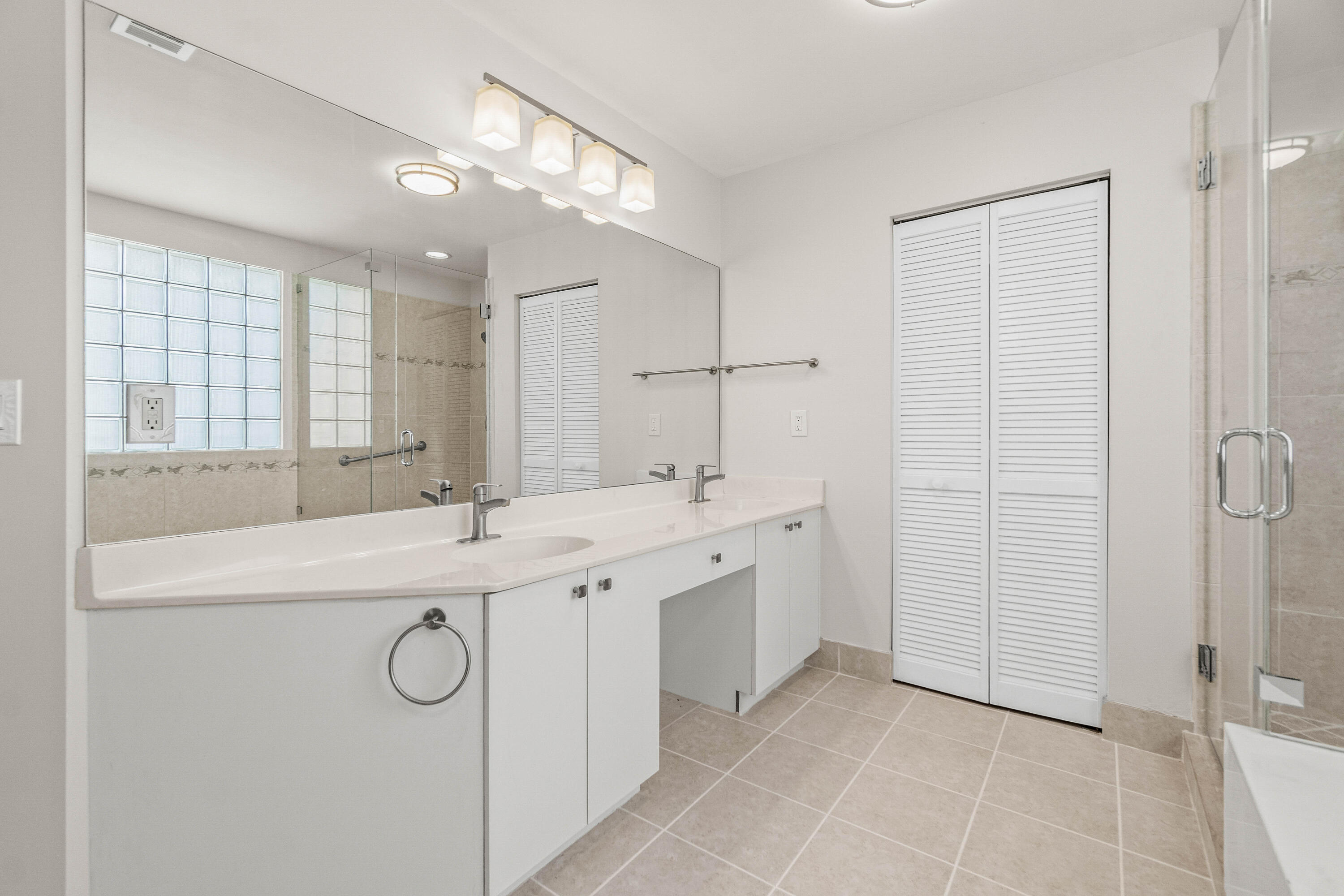 207 Pennock Trace Drive Jupiter, FL 33458 - Photo 21 of 48 a spacious bathroom with a double vanity sink a mirror and a shower