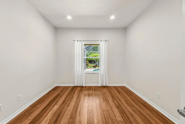 a view of a room with wooden floor and window