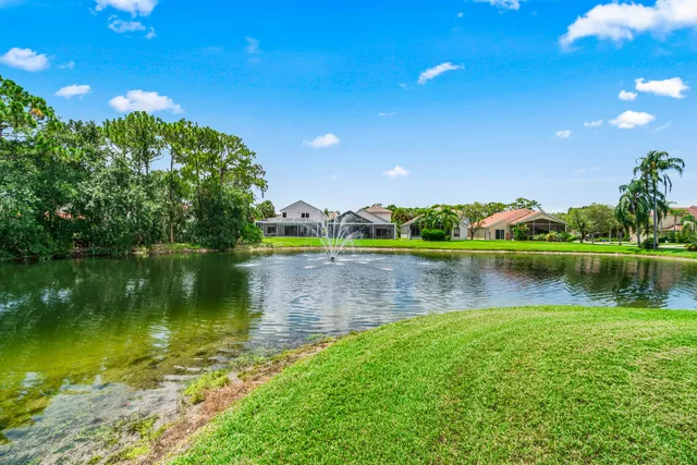 a view of a lake with a house in the background