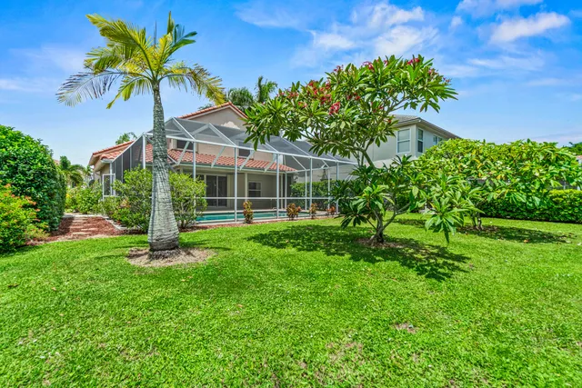 a view of a house with a backyard