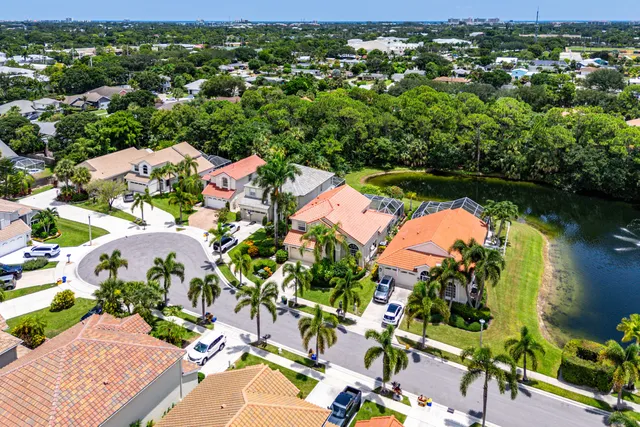 an aerial view of residential houses with outdoor space and trees