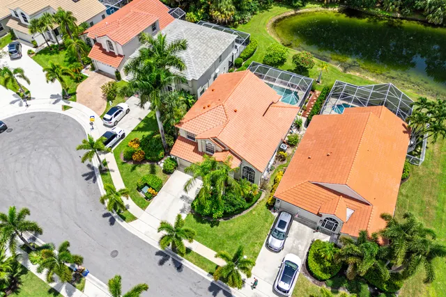 an aerial view of a house with a yard and garden