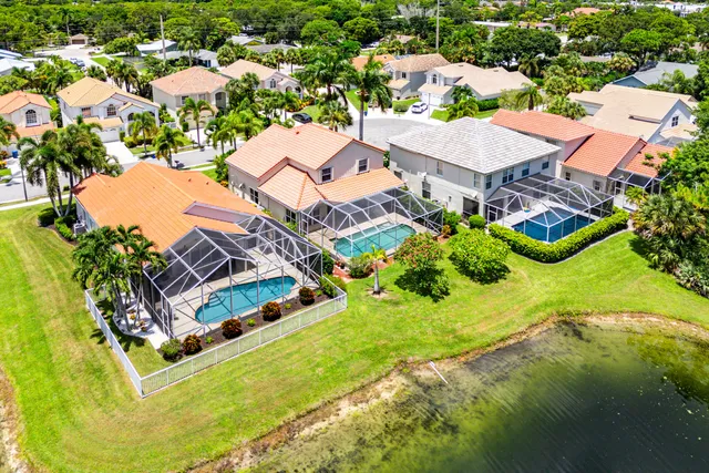 an aerial view of a house with a garden and swimming pool