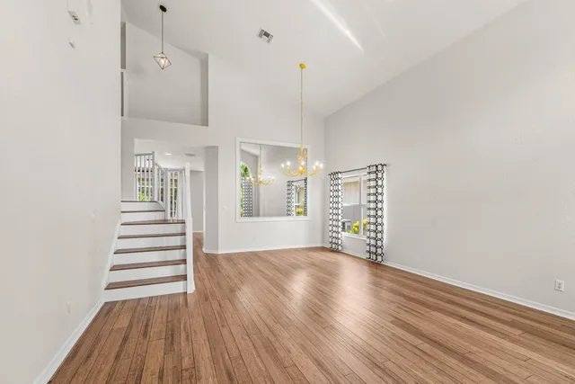 a view of a kitchen with wooden floor and window