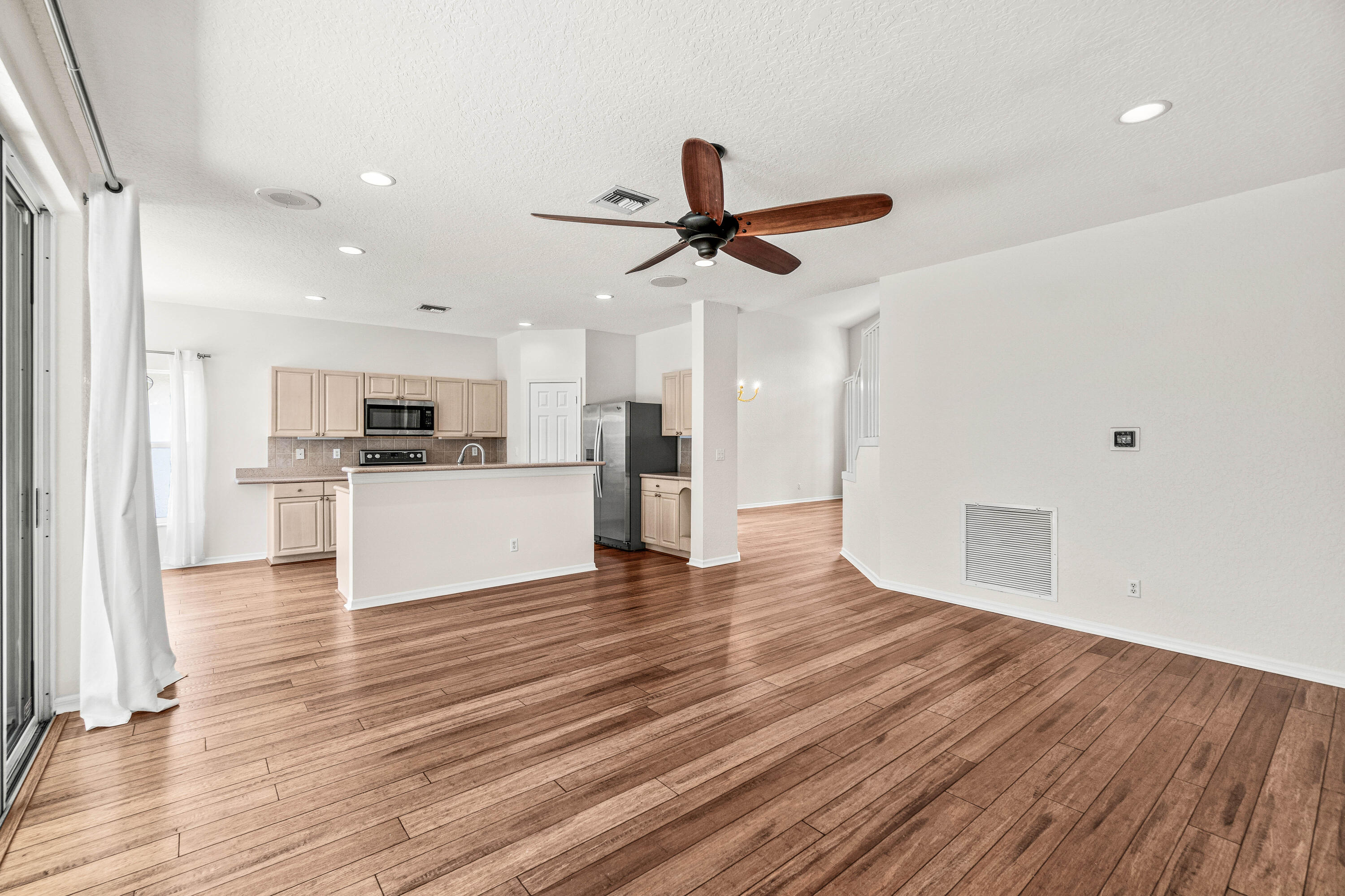 207 Pennock Trace Drive Jupiter, FL 33458 - Photo 7 of 48 a view of a kitchen with a sink and a refrigerator
