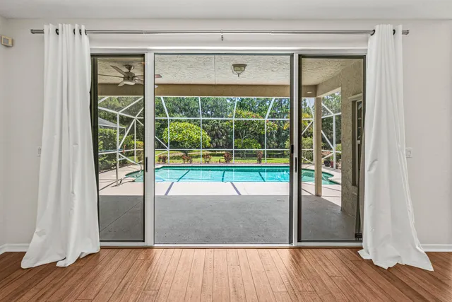 a view of a room with wooden floor and windows