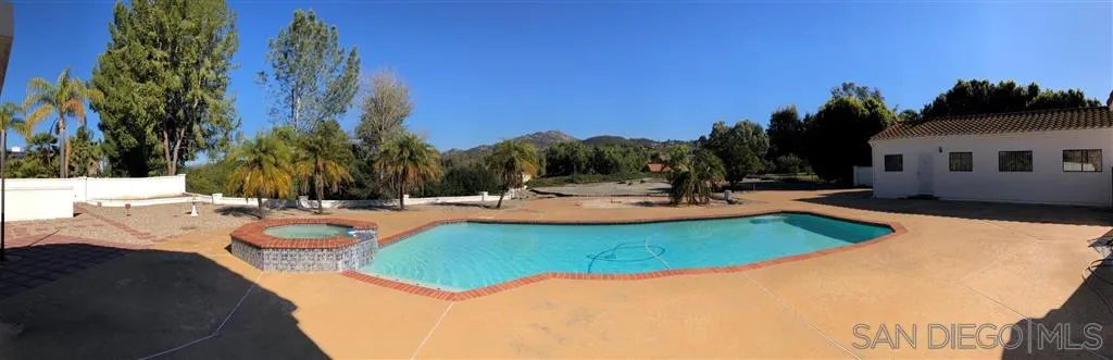 15855 Riparian Road Poway, CA 92064 - Photo 1 of 1 a view of a swimming pool with an outdoor space and seating area