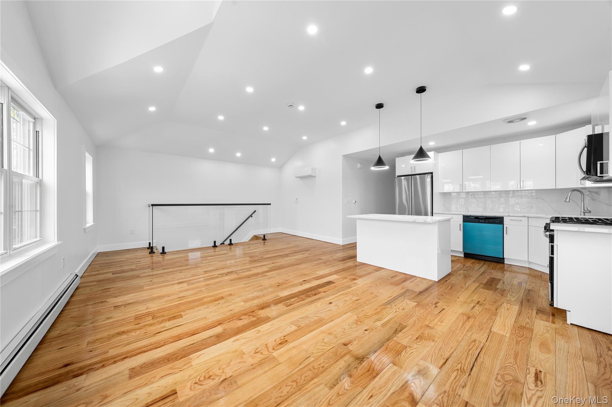a view of a kitchen with a sink and a refrigerator