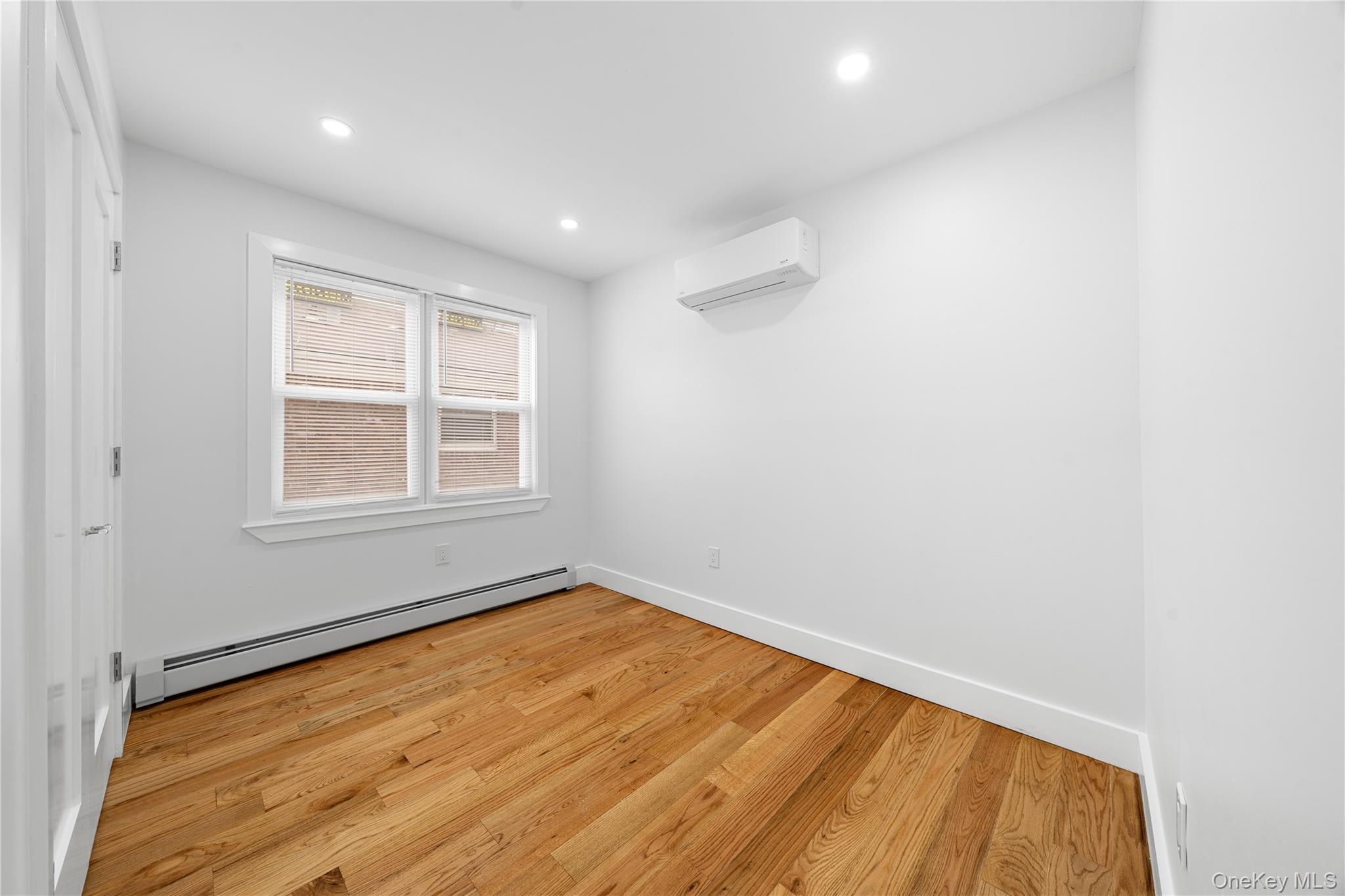 245-33 147th Road, Unit 2 Queens, NY 11422 - Photo 11 of 17 an empty room with a window