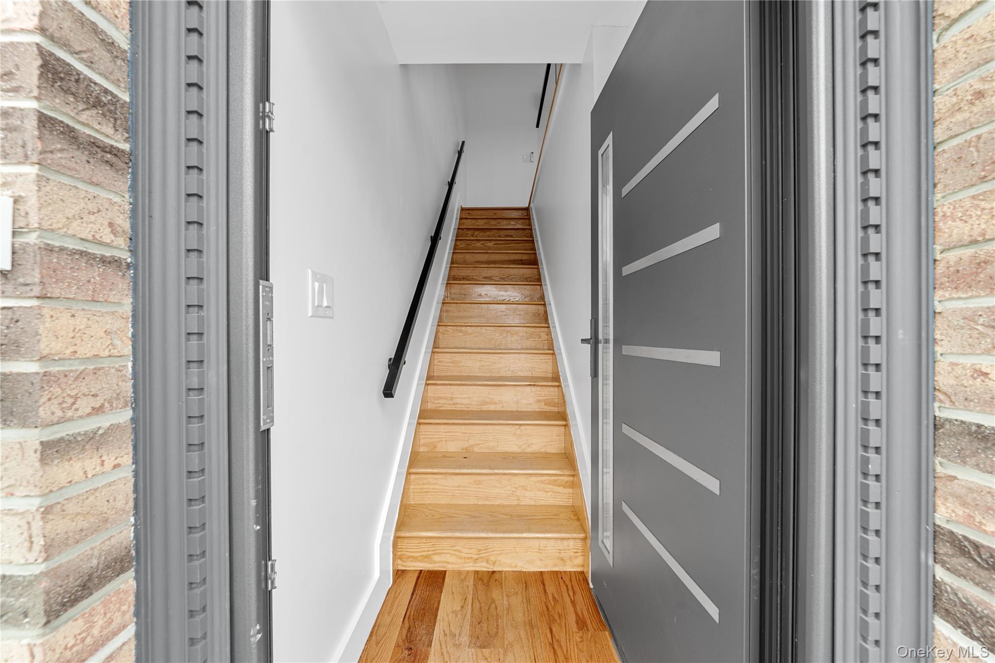 245-33 147th Road, Unit 2 Queens, NY 11422 - Photo 2 of 17 a view of entryway with wooden floor and stairs