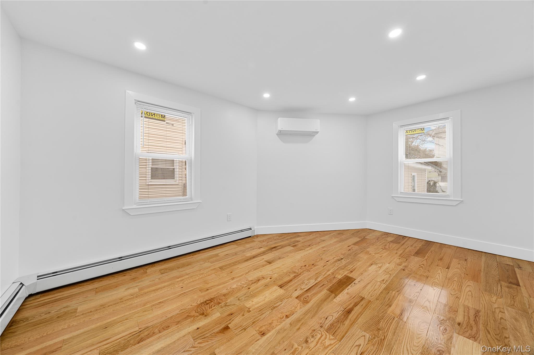 245-33 147th Road, Unit 2 Queens, NY 11422 - Photo 9 of 17 a view of empty room with wooden floor and fan