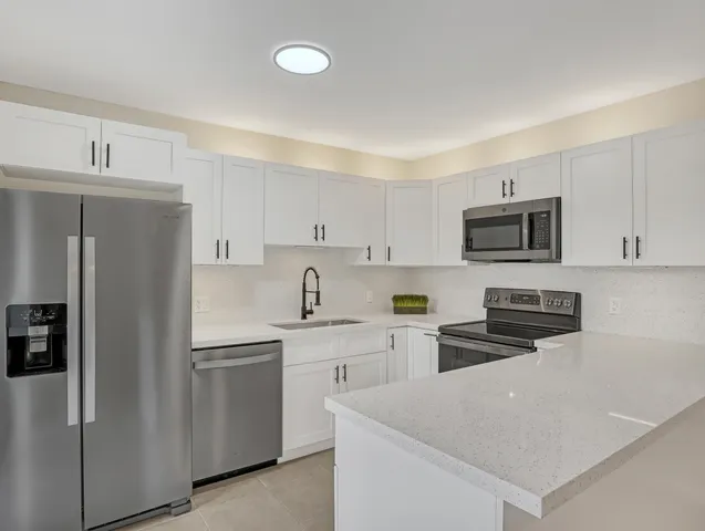 a view of a hallway to a livingroom with furniture