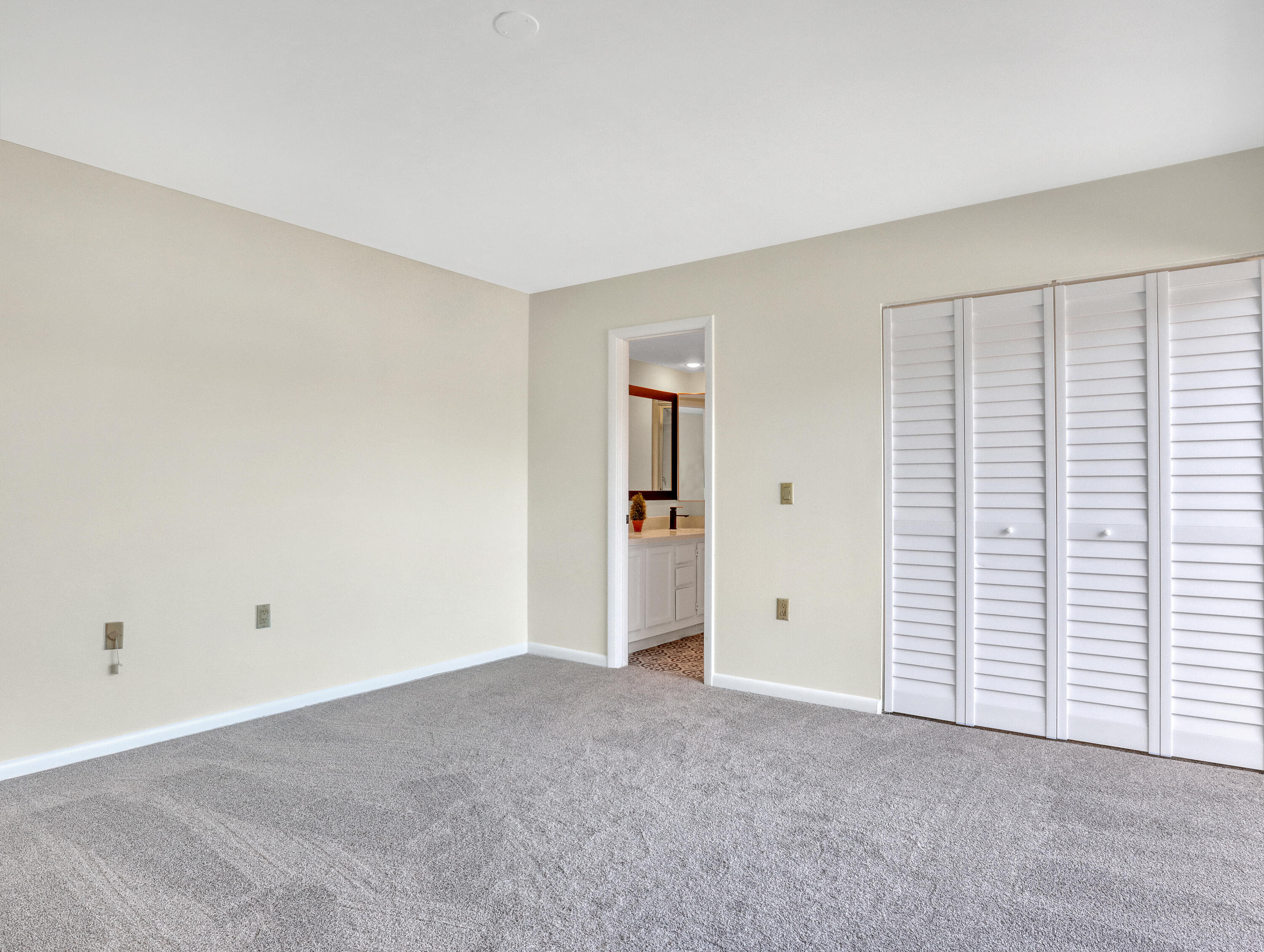 5738 Southeast Windsong Lane, Unit 315 Stuart, FL 34997 - Photo 19 of 32 wooden floor and white walls