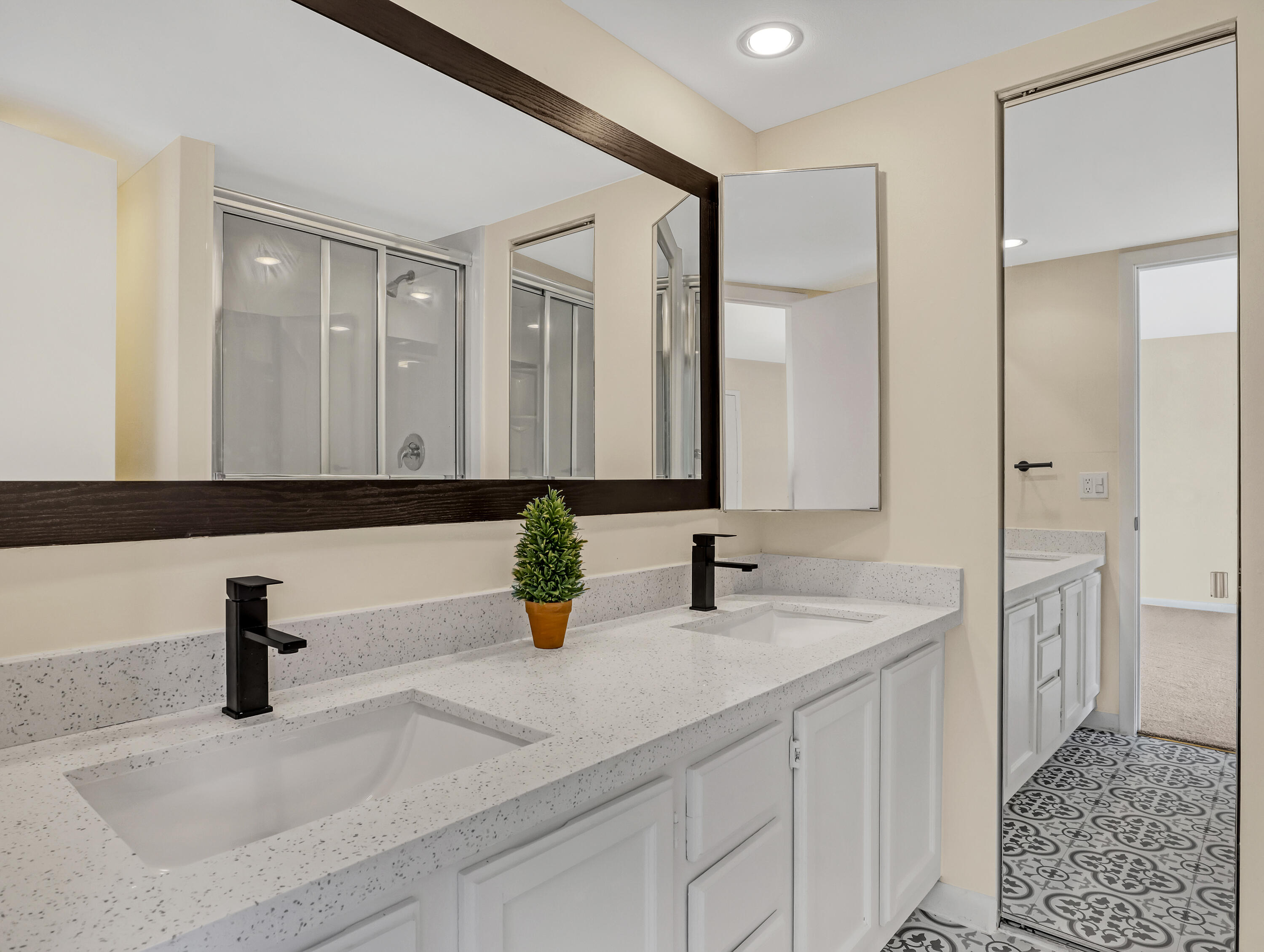 5738 Southeast Windsong Lane, Unit 315 Stuart, FL 34997 - Photo 21 of 32 a bathroom with sink and mirror