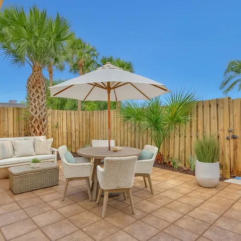 a patio with a patio table and chairs