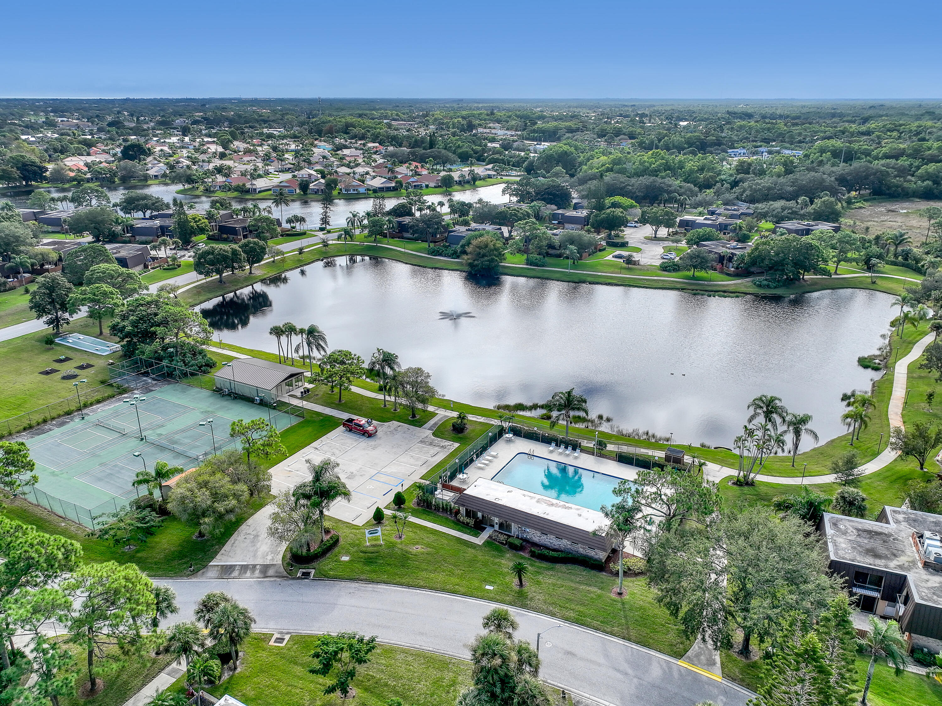 5738 Southeast Windsong Lane, Unit 315 Stuart, FL 34997 - Photo 31 of 32 an aerial view of a house with a lake view