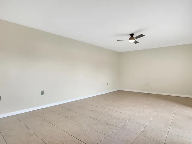 a view of an empty room with a fan