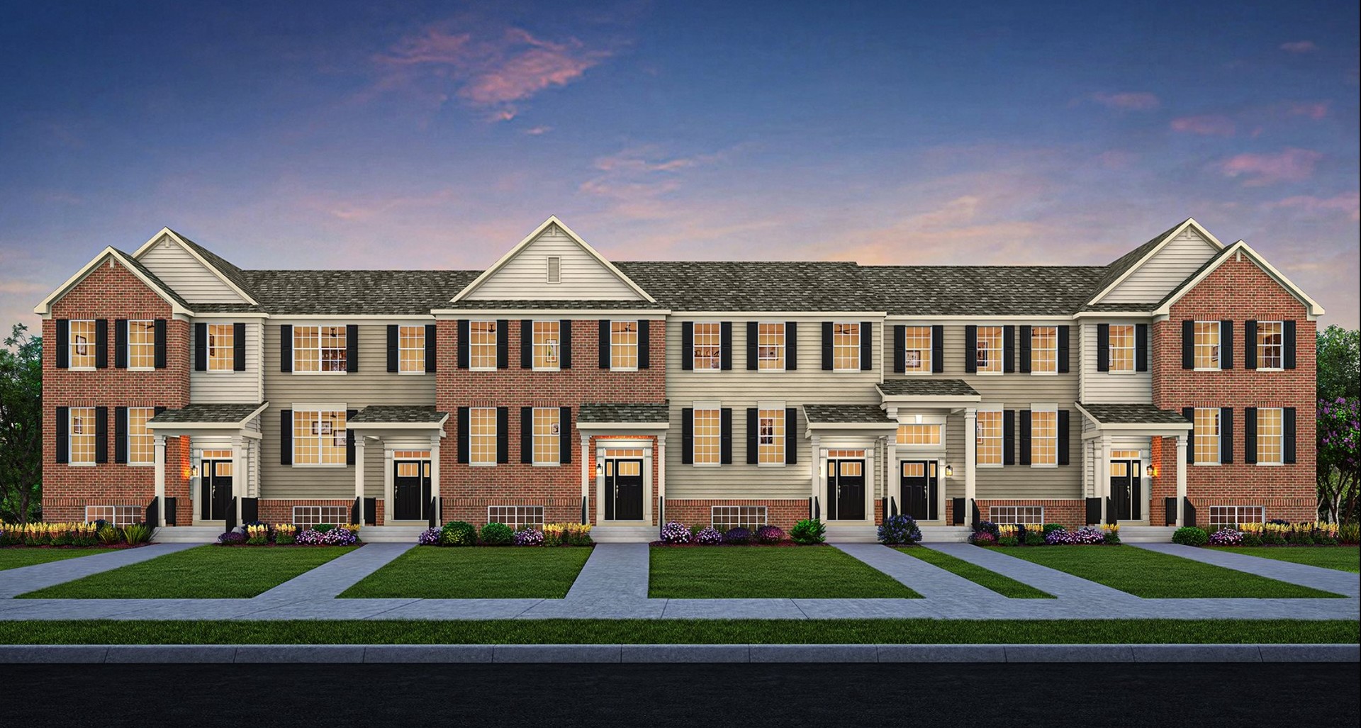 front view of a brick house next to a yard