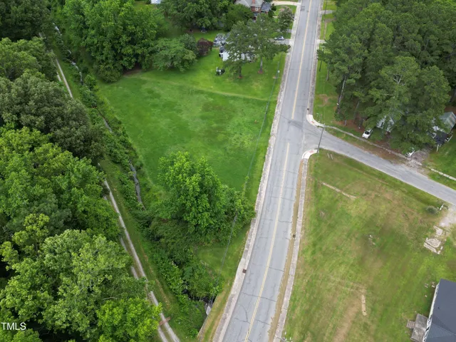 a view of a yard with potted plants