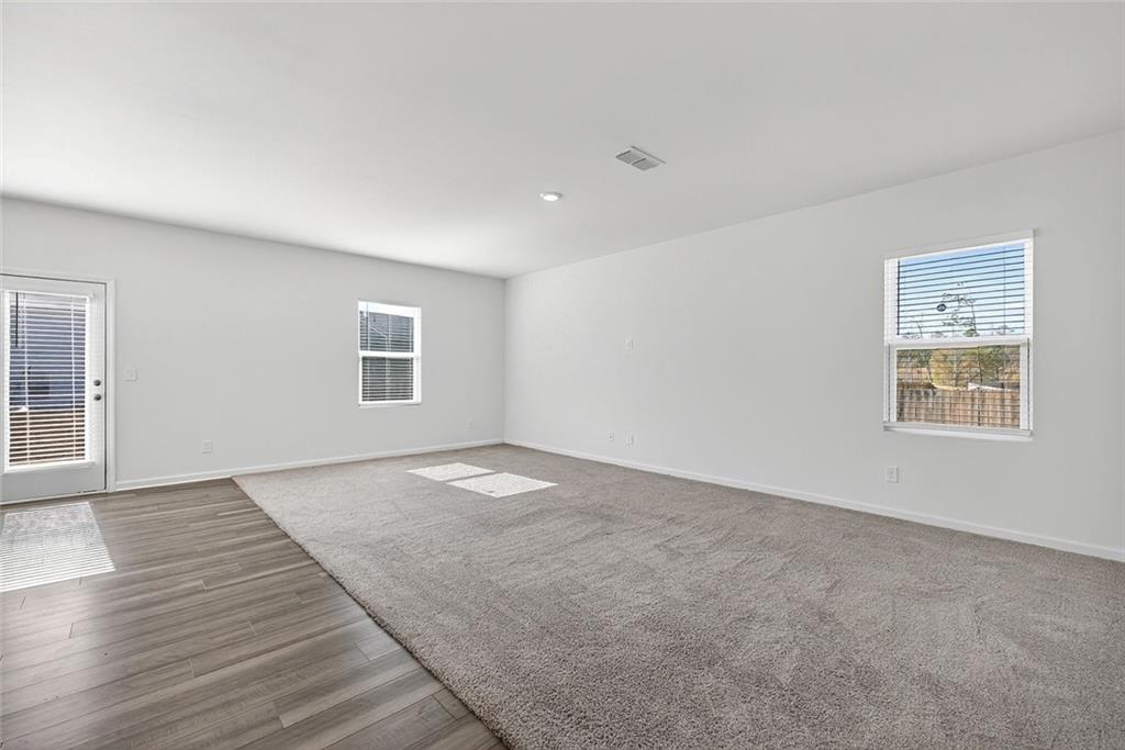 214 Georgian Way Locust Grove, GA 30248 - Photo 12 of 31 a view of empty room with wooden floor and fan