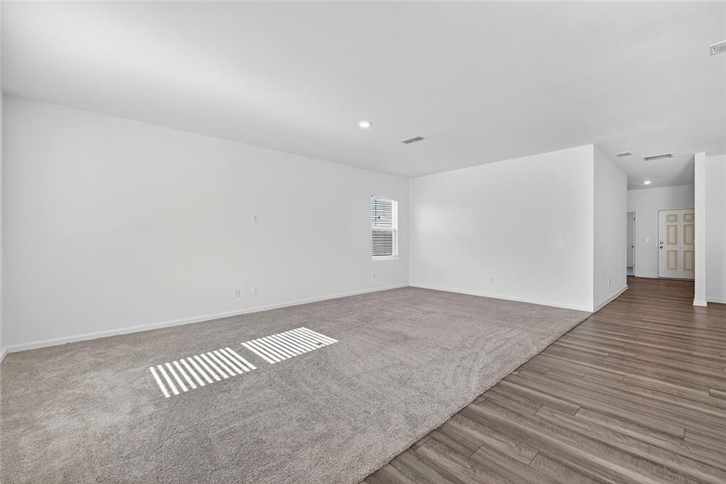 214 Georgian Way Locust Grove, GA 30248 - Photo 13 of 31 an empty room with wooden floor