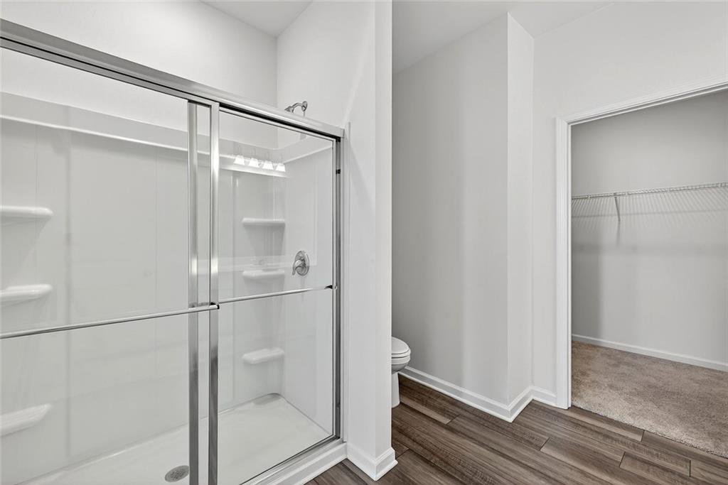 214 Georgian Way Locust Grove, GA 30248 - Photo 17 of 31 a bathroom with a glass shower door