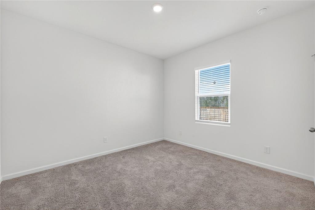 214 Georgian Way Locust Grove, GA 30248 - Photo 18 of 29 an empty room with a window