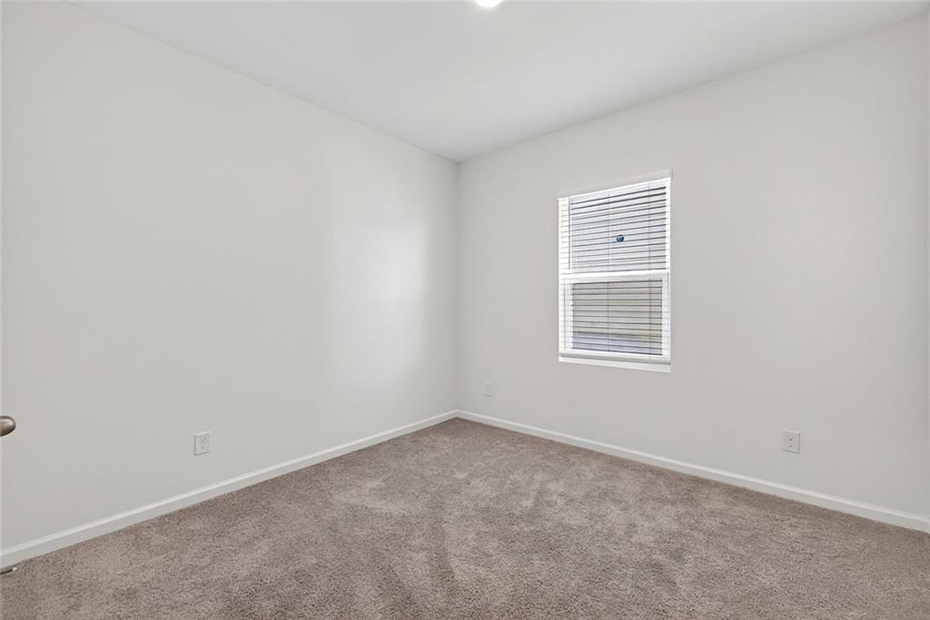 214 Georgian Way Locust Grove, GA 30248 - Photo 20 of 29 an empty room with a window