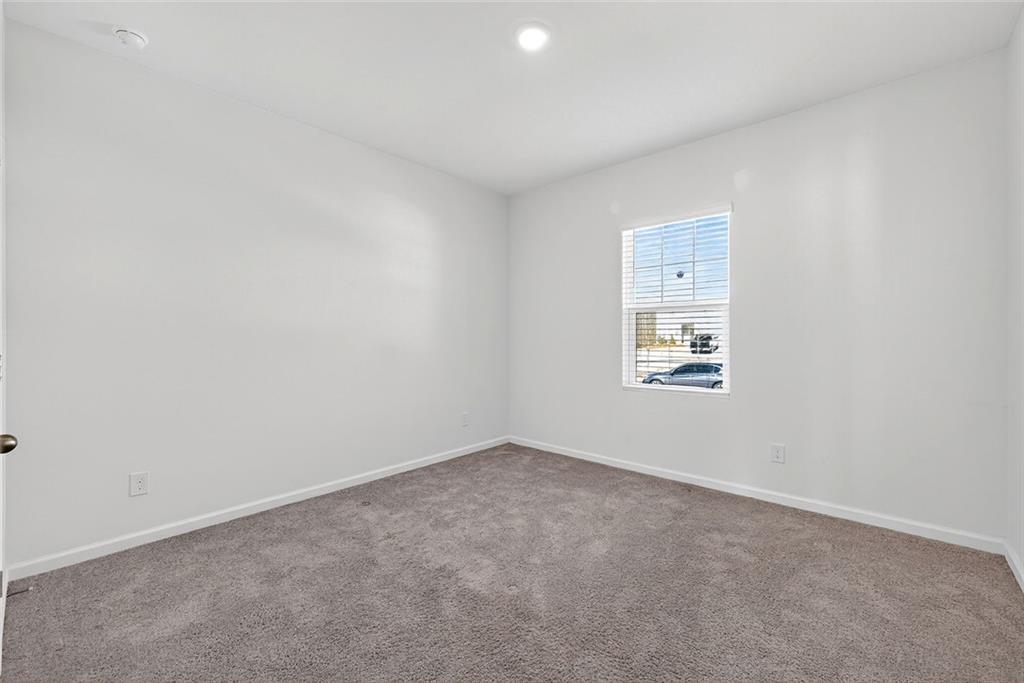 214 Georgian Way Locust Grove, GA 30248 - Photo 22 of 31 an empty room with a workbench