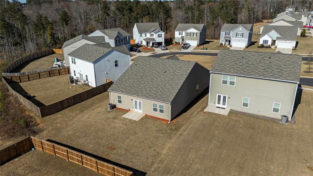 214 Georgian Way Locust Grove, GA 30248 - Photo 27 of 31 a view of a house with roof deck and couches