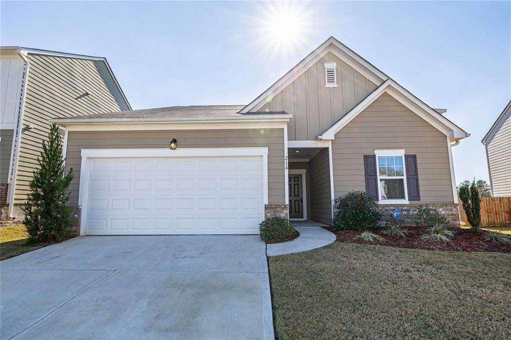 214 Georgian Way Locust Grove, GA 30248 - Photo 3 of 31 a view of house with garage and plants