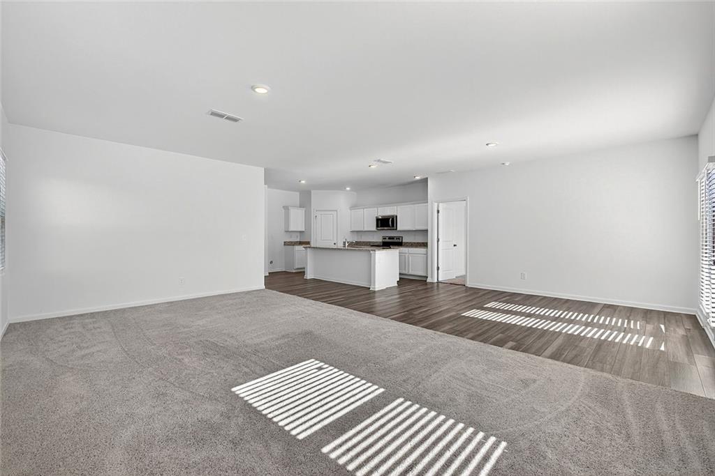 214 Georgian Way Locust Grove, GA 30248 - Photo 10 of 31 a view of kitchen and empty room