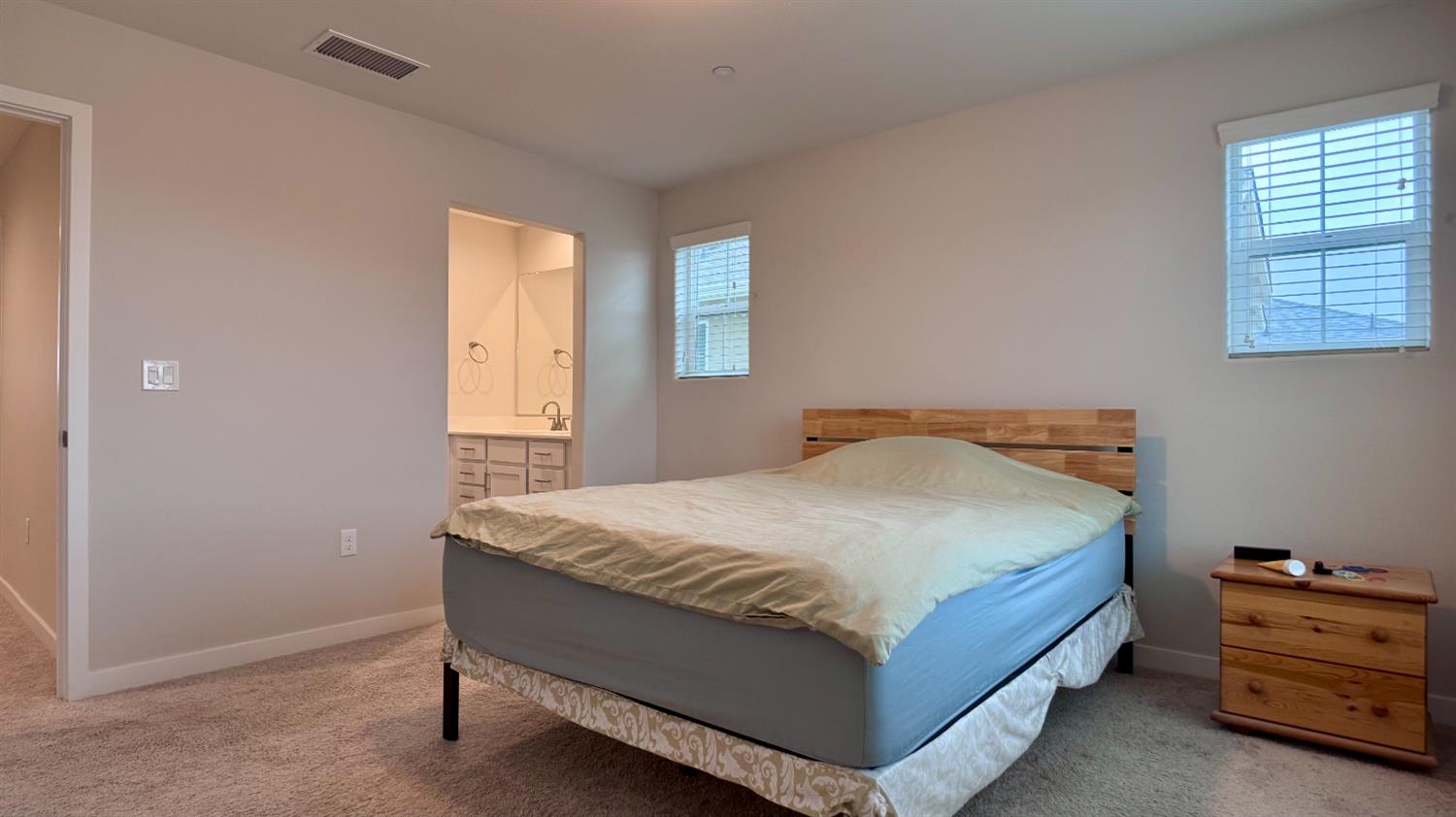 4163 Vincent Road Madera, CA 93636 - Photo 13 of 17 a bed sitting in a bedroom next to a window